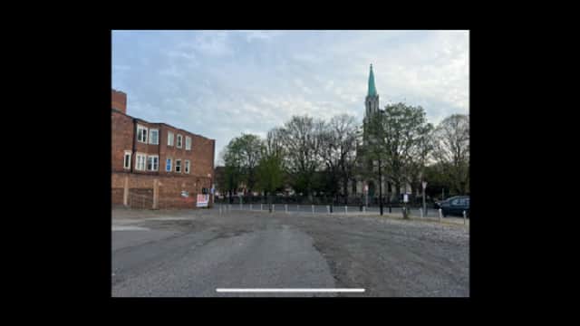 Pay & Display parking area in Doncaster, featuring a church tower and trees in the background.