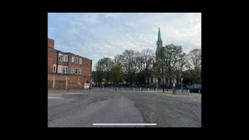 Pay & Display parking area in Doncaster, featuring a church tower and trees in the background.