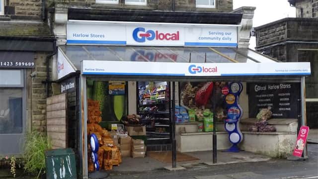 Harlow Stores with a colorful display of groceries, snacks, and drinks outside, located in a stone building in Harrogate.