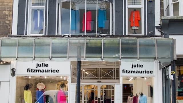 Clothes shop with colorful garments displayed in windows and a welcoming entrance in Harrogate, Yorkshire.