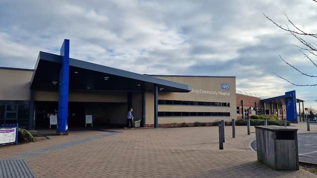 East Riding Community Hospital entrance with modern architecture, blue accents, and a paved pathway in front.