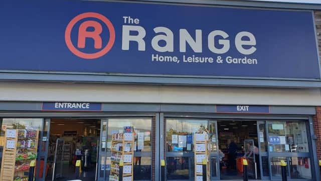 The Range store facade with large signage, entrance and exit doors, and displays of products outside.