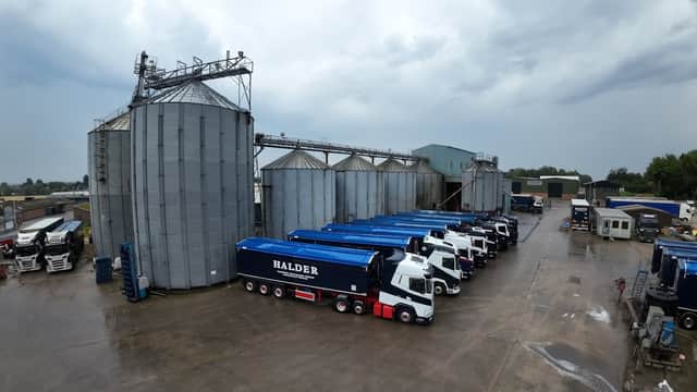 B I Halder Ltd facility with silos, trucks, and a cloudy sky in Hutton Cranswick, Yorkshire.