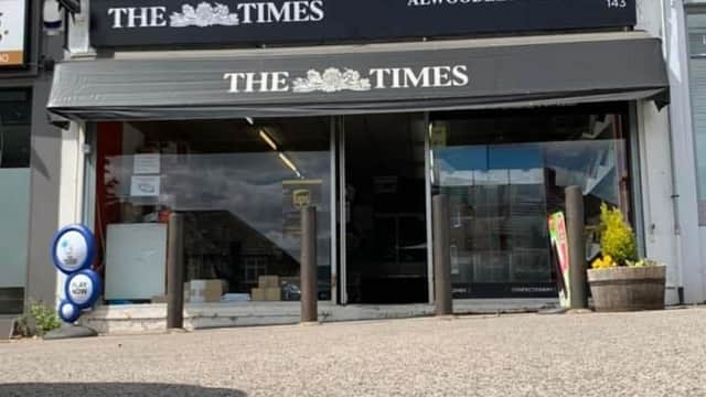 Alwoodley Park News shopfront with a black awning, displaying "THE TIMES," and a small flower planter outside.