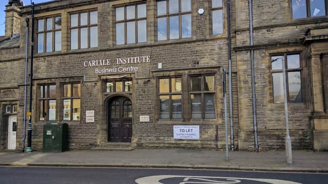 Historic stone building with large windows, featuring a sign for The Carlile Institute Business Centre and a "To Let" notice.