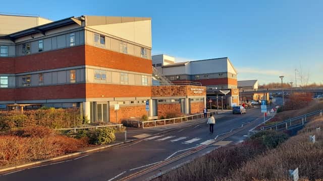 Car park with modern buildings, pedestrian walkways, and landscaped areas under a clear blue sky in Middlesbrough.