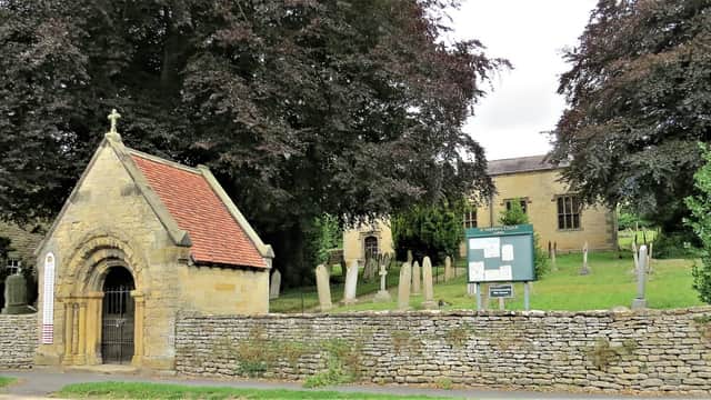 St Stephen's Church with stone walls, gravestones, and lush trees in Snainton, Yorkshire.