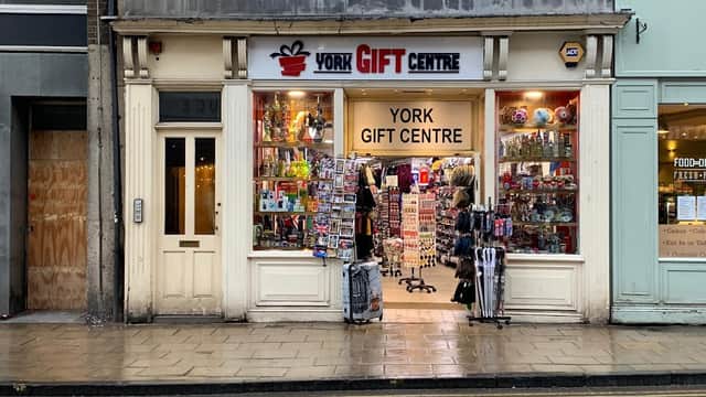 Storefront of York Gift Centre with colorful merchandise displays and a welcoming entrance on a rainy street.