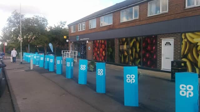 Co-op Food storefront in Wetherby with colorful fruit murals and blue signage along the pavement.