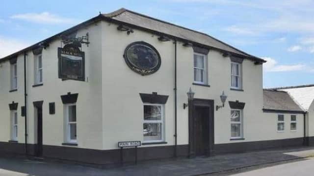 The Black Bull B&B, a cream-colored building with a sign and decorative features, located in Burton Pidsea, Yorkshire.