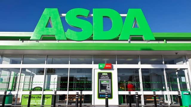 Bright green "ASDA" signage above a glass entrance with a cash machine and parking information in Shipley, Yorkshire.