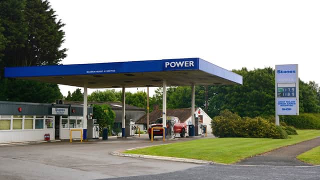 Gas station with "POWER" signage, fuel pumps, and a shop, surrounded by greenery in West Heslerton, Yorkshire.