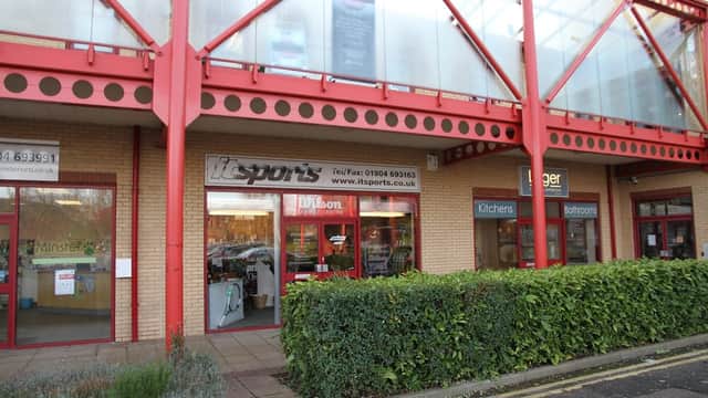 IT Sports shop front with large windows, showcasing sports equipment, located in a modern building in York, Yorkshire.