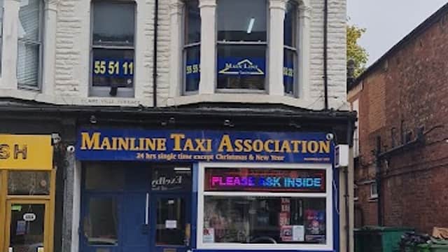 Mainline Taxi Association storefront in Harrogate, featuring blue signage and large windows on a two-story building.