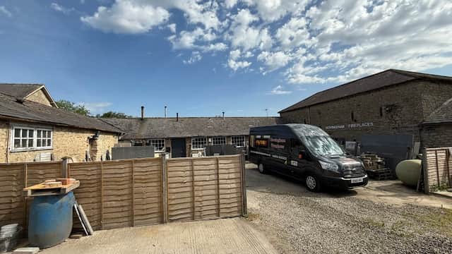 Hovingham Fireplaces & Stoves shop with a delivery van, stone buildings, and a clear blue sky in Yorkshire.