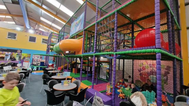 Colorful indoor play area with climbing structures, slides, and seating for parents in Ruswarp, Yorkshire.