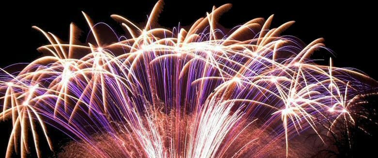Colorful fireworks bursting in the night sky, creating a vibrant display of light and patterns.
