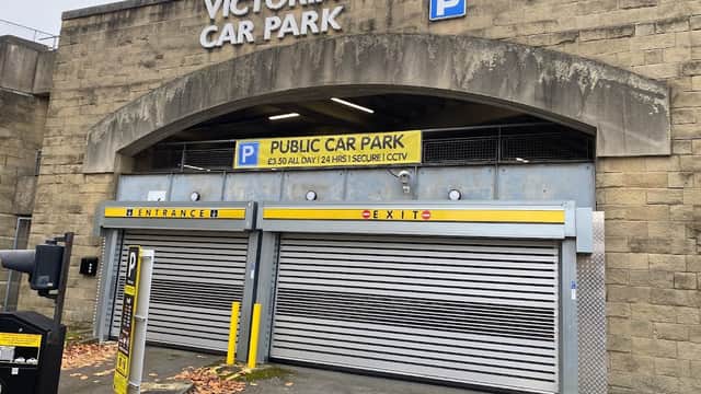 Victoria Quays Car Park entrance with signage, roller doors, and a parking fee notice in Sheffield, Yorkshire.