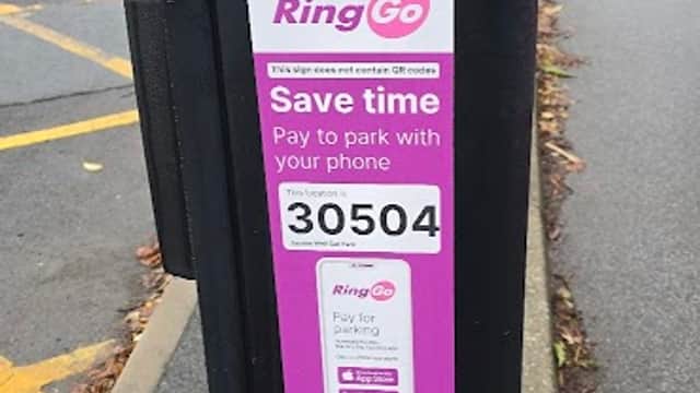 Parking meter with a "RingGo" payment sign, displaying instructions to pay by phone, in Jacobs Well Car Park, Bradford.