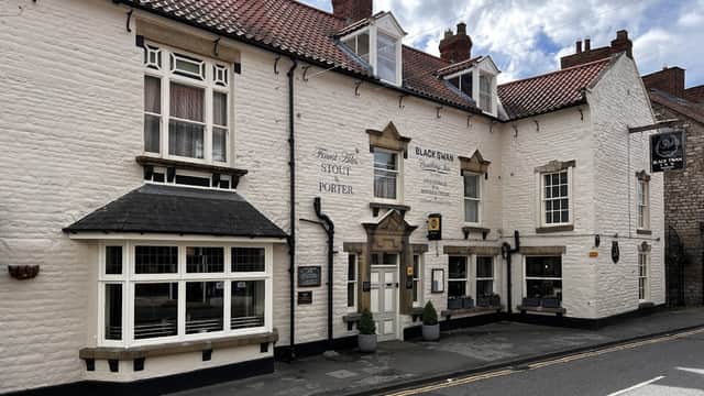 Charming white-washed building with a red tiled roof, featuring large windows and a welcoming entrance in Pickering.