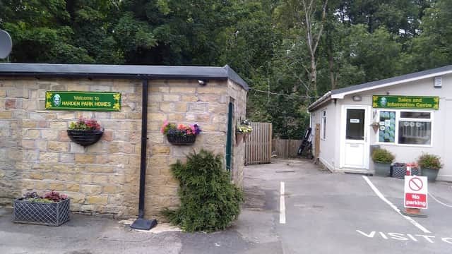 Welcome sign at Harden Park Homes, stone building with flower pots, and an information center with a no parking sign.