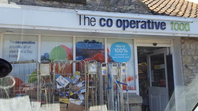 Co-op Food storefront with colorful signage, shopping carts, and boxes outside in Pickering, Yorkshire.
