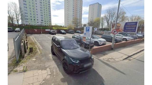 Pay & Display parking area in Killingbeck, Yorkshire, with multiple parked cars and high-rise buildings in the background.