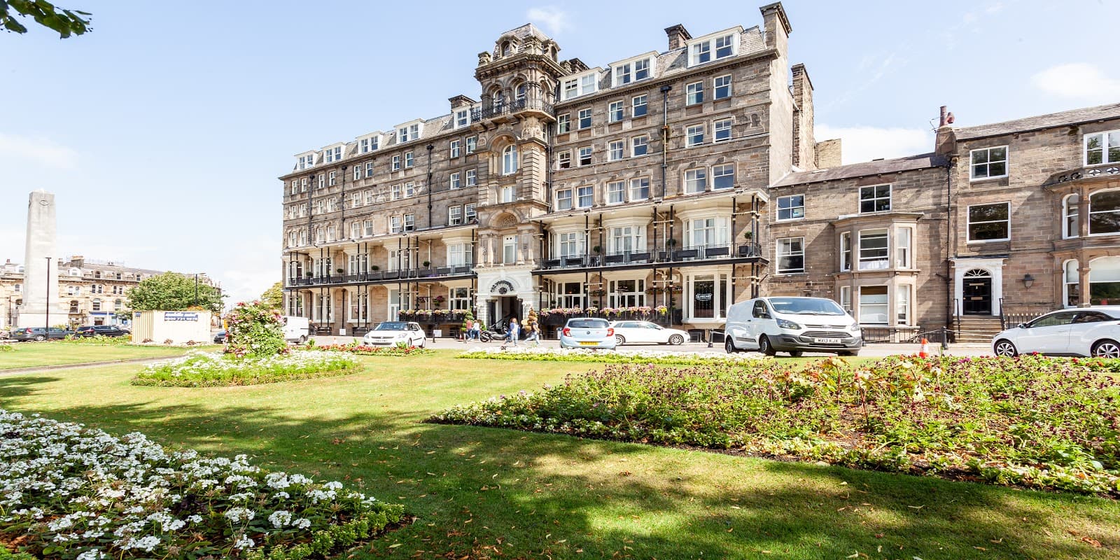 Historic building with ornate architecture, surrounded by greenery and parked cars, in Hilton, North Yorkshire.