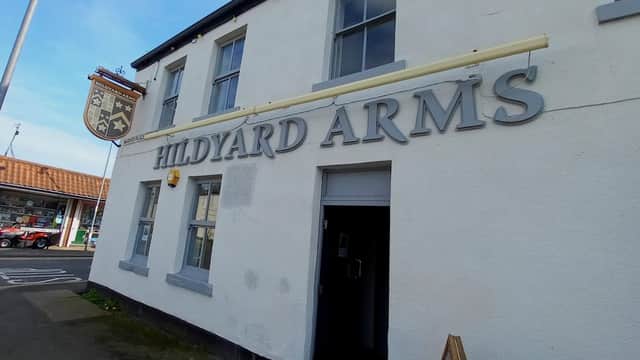 Hildyard Arms pub exterior with a sign, large windows, and a ladder against the wall in Patrington, Yorkshire.