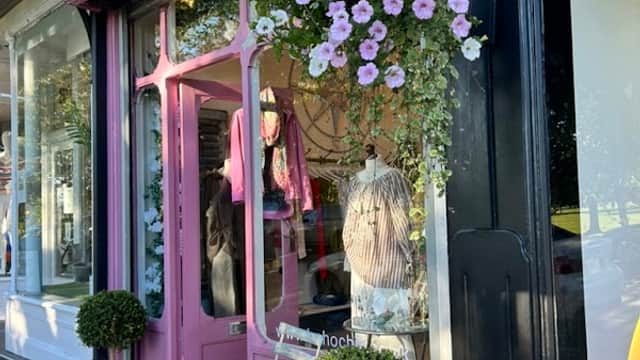 Pink storefront with "Boho Chic" sign, hanging flower basket, and topiary plants outside the shop in Harrogate.