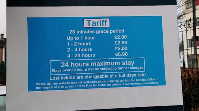 Sign for Pontefract Hospital's Visitors Car Park with tariff details and payment instructions. Pay & Display notice included.