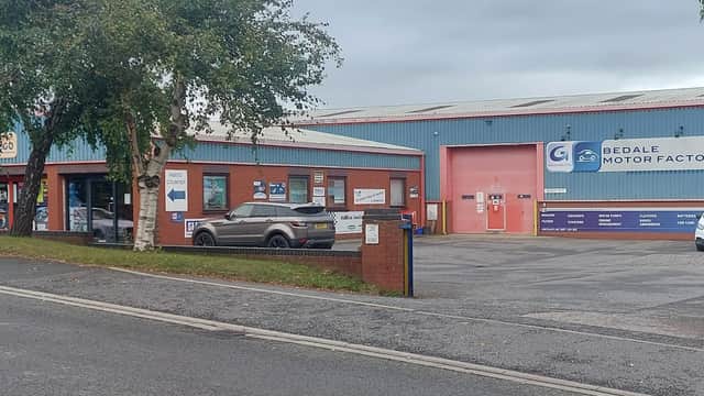 Bedale Motor Factors Ltd building with signage, parked cars, and surrounding greenery in Leeming Bar, Yorkshire.