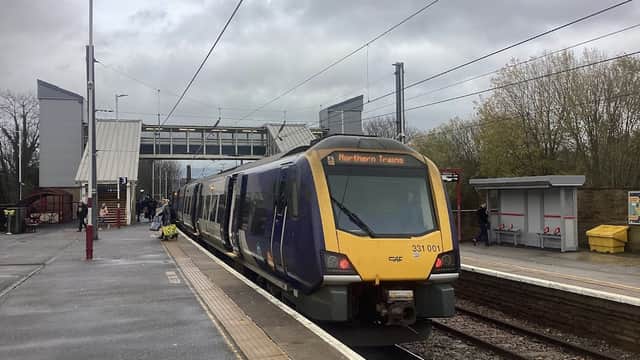 Northern Trains train at Shipley station, with platforms, shelter, and overcast sky in the background.