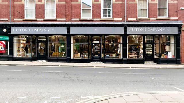 Futon Company storefront in York, featuring large windows displaying homeware and furniture against a red brick building.