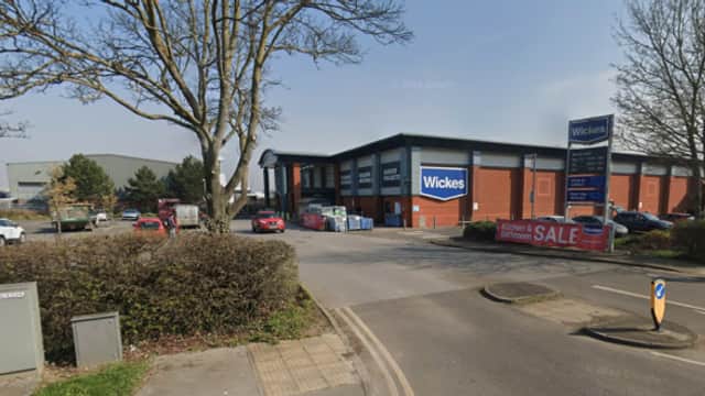 Wickes store in Beverley, Yorkshire, with parked cars, trees, and clear blue sky. Sale banner visible.