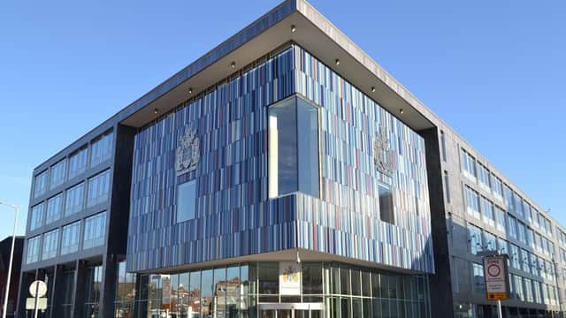 Modern building with colorful paneling, large windows, and the Doncaster Council emblem prominently displayed.