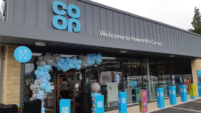 Welcome to Haworth's Co-op, featuring a modern entrance with blue and white balloon decorations and clear signage.
