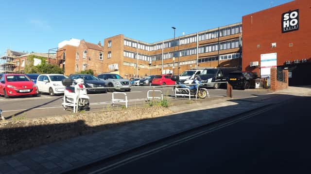 Grahams Orchard car park in Barnsley with parked cars, a building labeled "SOHO," and a clear blue sky.