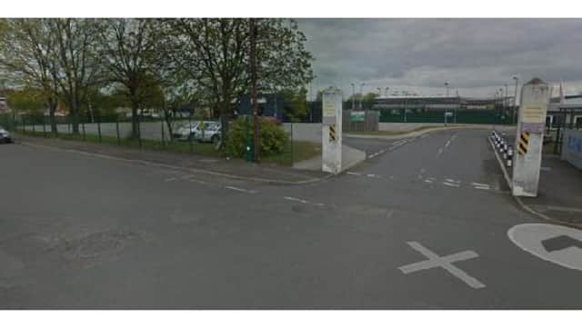 Pay & Display parking area in Doncaster, Yorkshire, with trees, a road, and a view of nearby facilities.