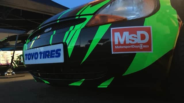 Green and black striped car with Toyo Tires and MotorsportDays logos, parked at Shine Automotive Thirsk.