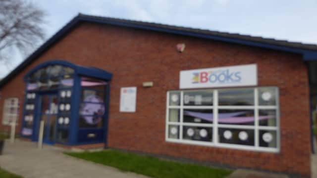 Brick building with large windows, blue trim, and a sign reading "More Than Books" in Eastfield, North Yorkshire.