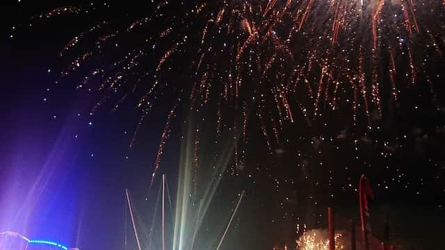 Colorful fireworks illuminate the night sky above a crowd enjoying a festive event at Burgoyne Park in Aston.
