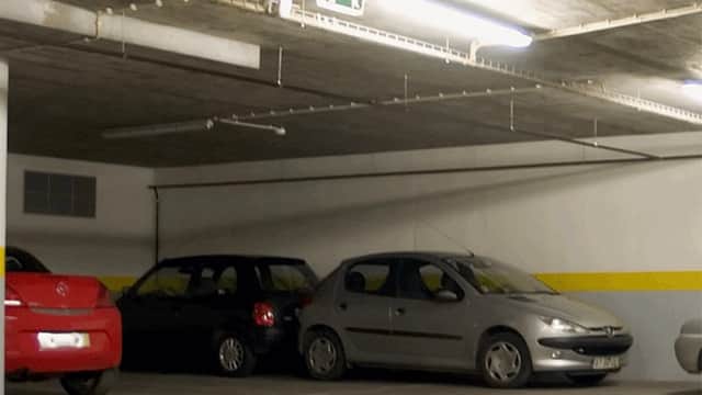 Pay & Display parking area with parked cars, yellow wall stripe, and overhead lighting in Bramhope, Yorkshire.