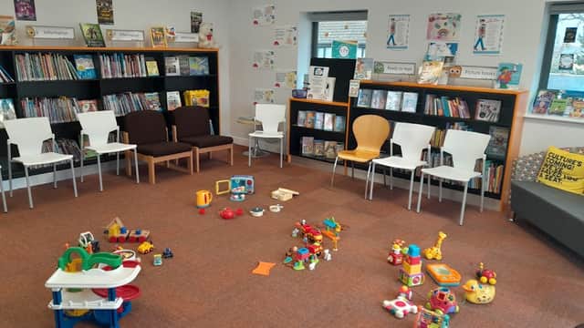 Bright children's area with colorful toys, bookshelves, and seating in Wickersley Library, Yorkshire.