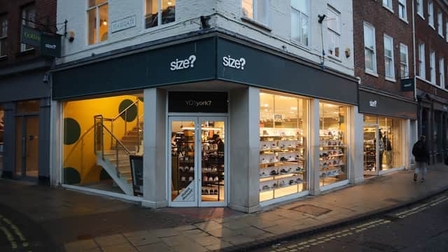 Clothing shop "size?" in Leeds, featuring large windows, a staircase, and displays of footwear.