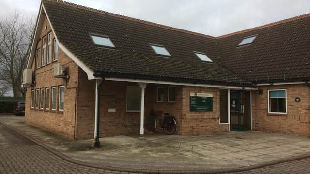 Brick building with a sloped roof, windows, sign for Beech Tree Surgery, and a bicycle outside in Brayton, North Yorkshire.