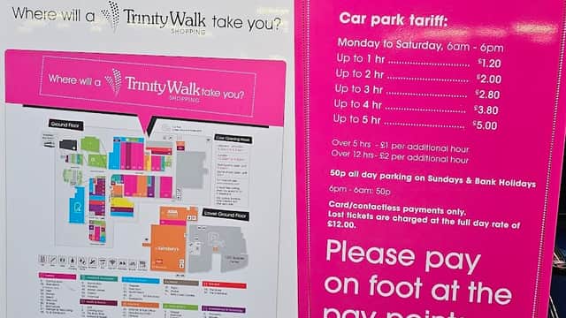 Signage for Trinity Walk Car Park with parking rates, hours, and a map of the shopping area in Wakefield, Yorkshire.