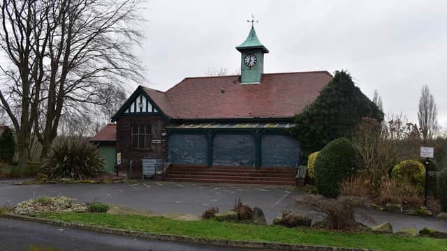 Historic building with a clock tower, surrounded by greenery and parking spaces at Vale Head Park, Kinsley, Yorkshire.