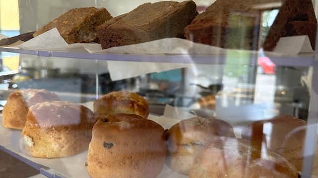 Brownies and scones displayed in a glass case at Wok Inn Ivy Bank, showcasing baked goods in a cozy setting.