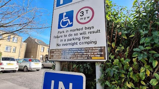 Sign for Albion Street Car Park in Tingley, Yorkshire, displaying parking rules and free parking information.